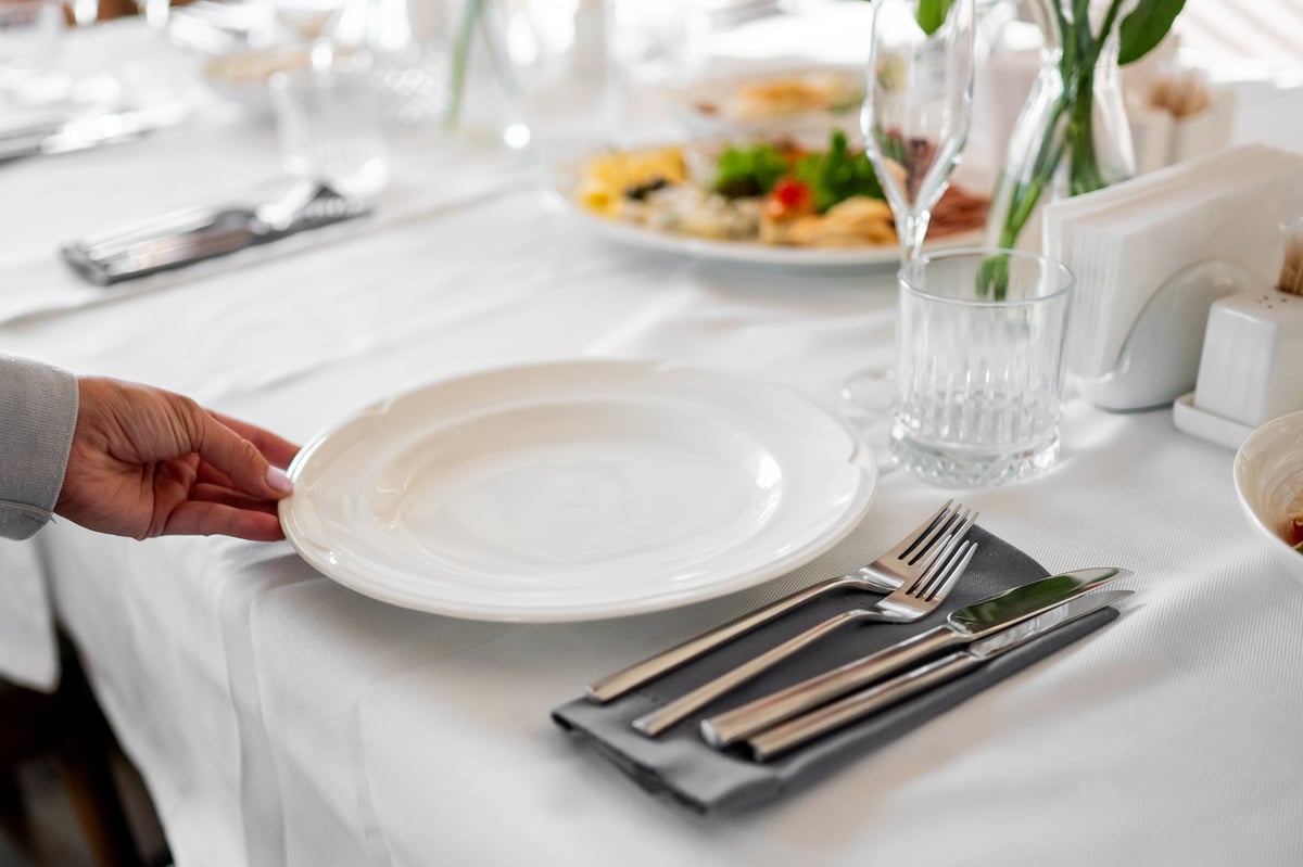 Fine dining course served beside clear mineral water in glassware
