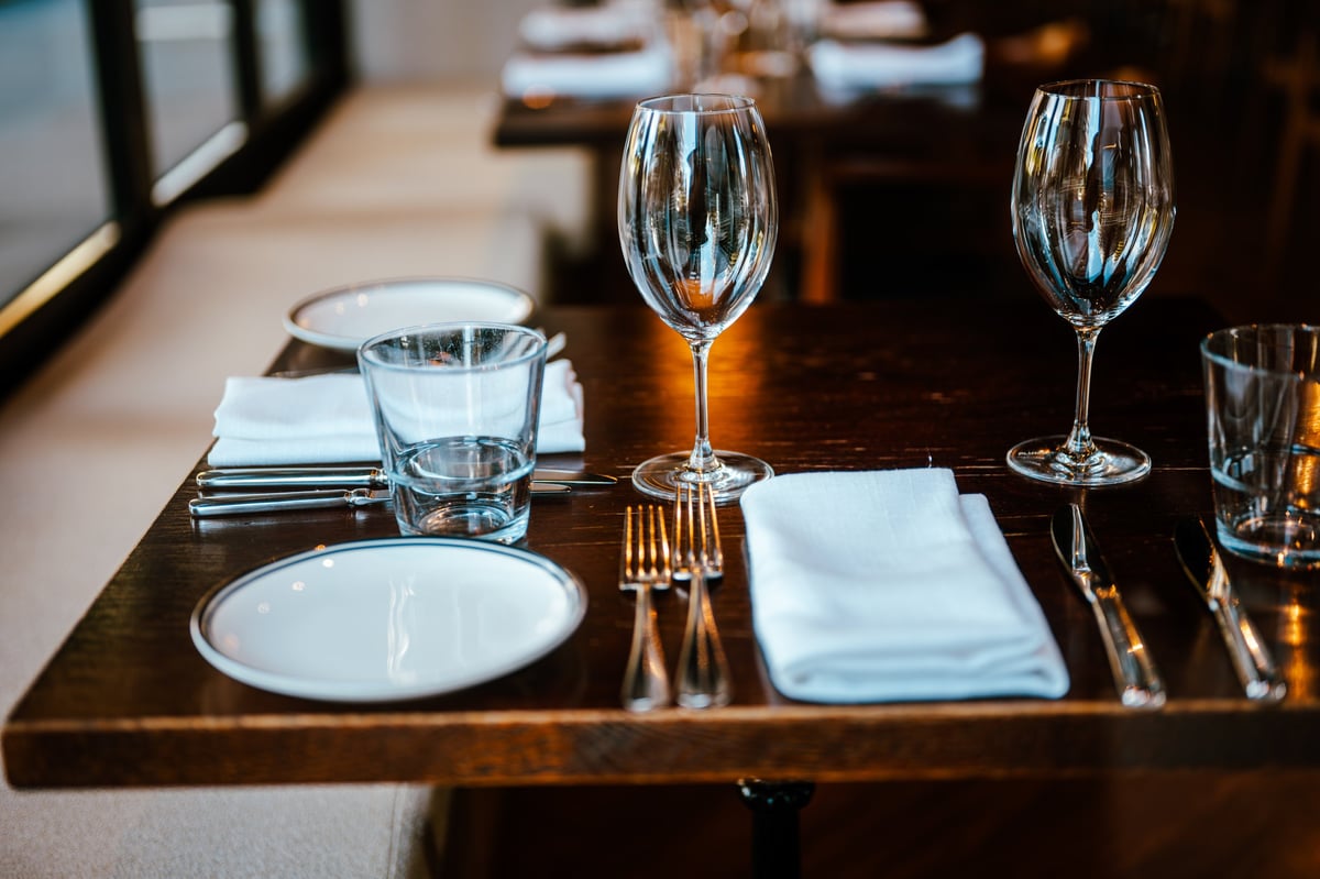 Elegant restaurant table setting with wine glasses and cutlery