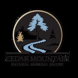 Cedar Mountain Natural Mineral Water logo featuring a circular emblem with stylized trees, mountains, and a winding blue stream