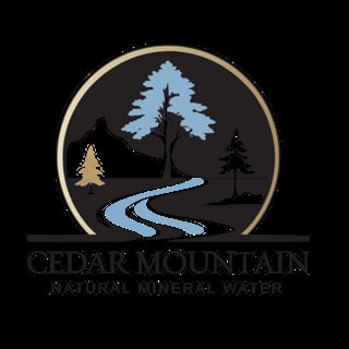 Cedar Mountain Natural Mineral Water logo featuring a circular emblem with stylized trees, mountains, and a winding blue stream