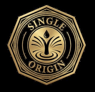 Gold octagonal badge with Single Origin text and a stylized water drop lotus design on black background