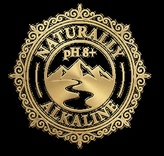 Gold ornate circular badge with mountains, water, and pH 8+ text reading Naturally Alkaline on black background