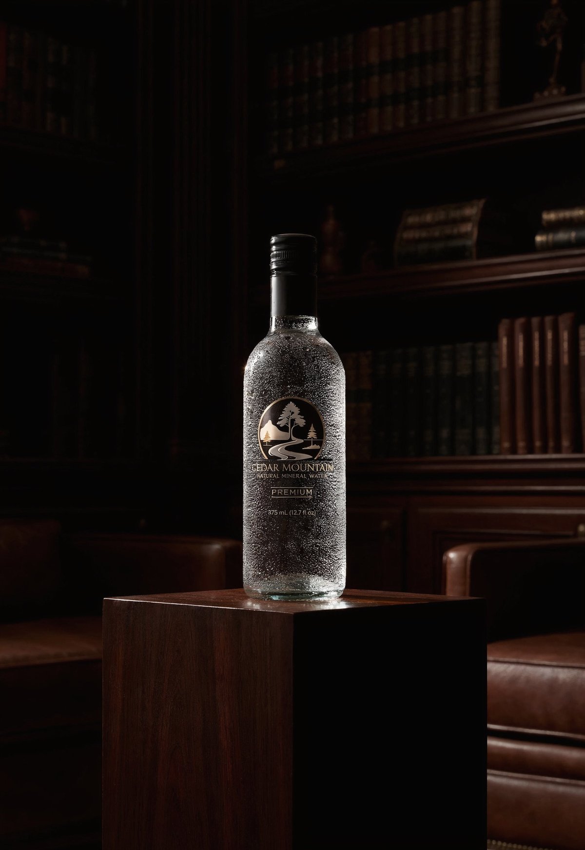 A frosted vodka bottle with a bear logo displayed on a dark wooden pedestal