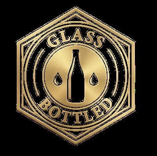 Gold hexagonal badge with glass bottle and droplets, text reading Glass Bottled around the border